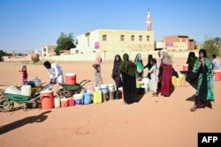 People queue for water in Omdurman, Sudan, during battles between the Sudanese military and paramilitary Rapid Support Forces, Jan. 16, 2025. Most of Omdurman is under army control; the RSF holds Khartoum North and some other areas of the capital.